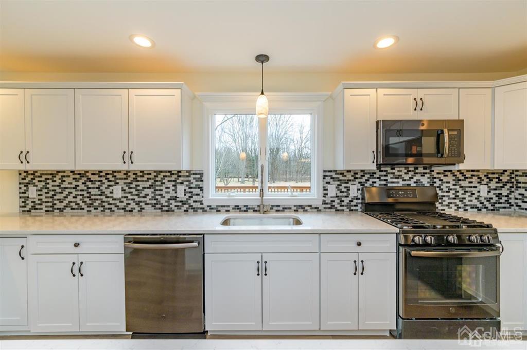 11 Little Philadelphia Road Washington, NJ 07882 - Photo 16 of 48 a kitchen with a sink stove and microwave