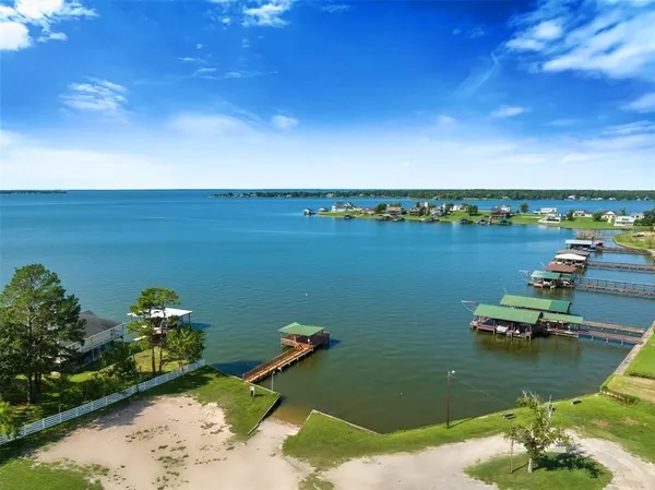 a view of a lake with lawn chairs