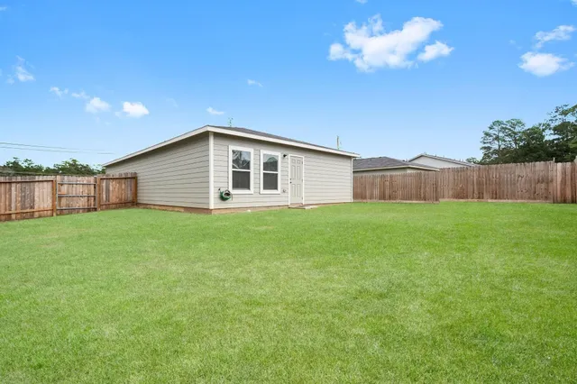 a view of a house with a backyard