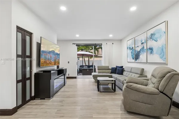 a living room with furniture and a flat screen tv