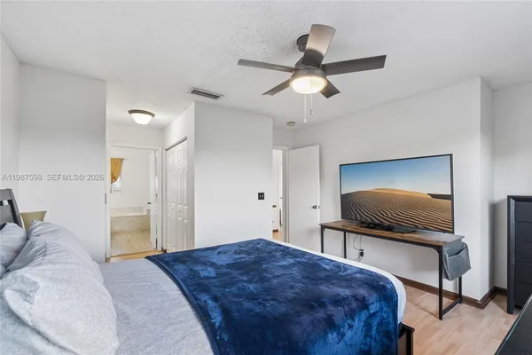 a bedroom with a bed and a flat screen tv