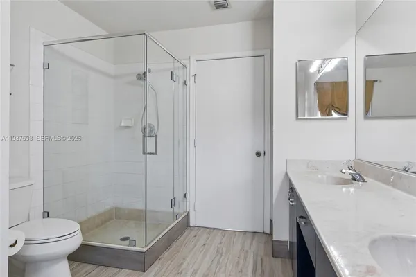a bathroom with a sink toilet and shower