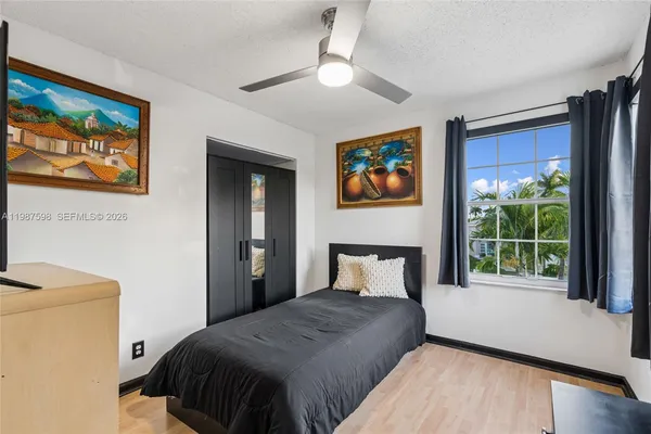 a bedroom with a bed and a painting on the wall