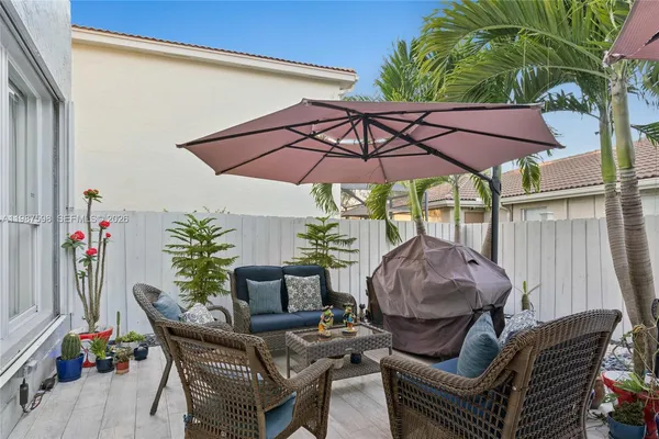 a patio with a patio table and chairs