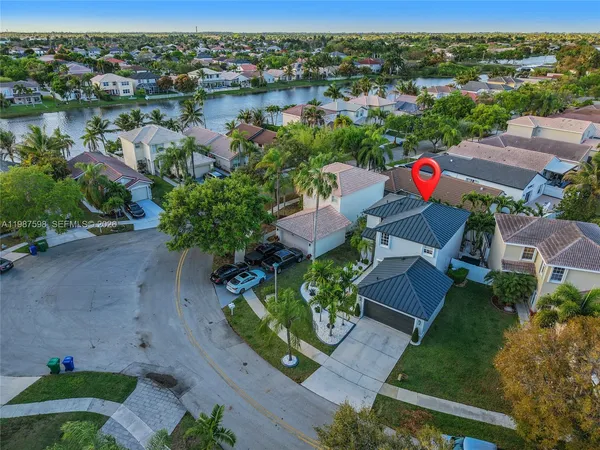 an aerial view of a house with a lake view