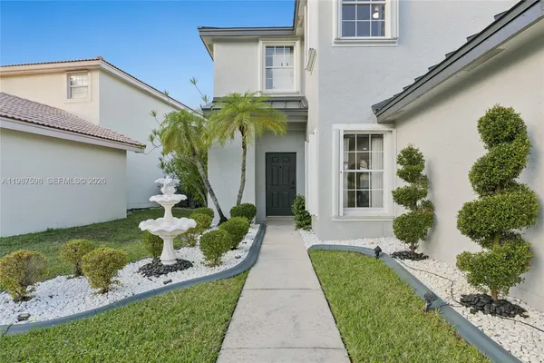 a front view of a house with garden