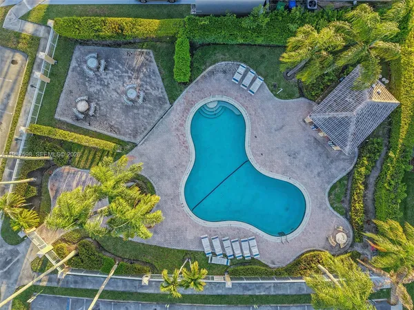 an aerial view of a swimming pool patio and outdoor seating