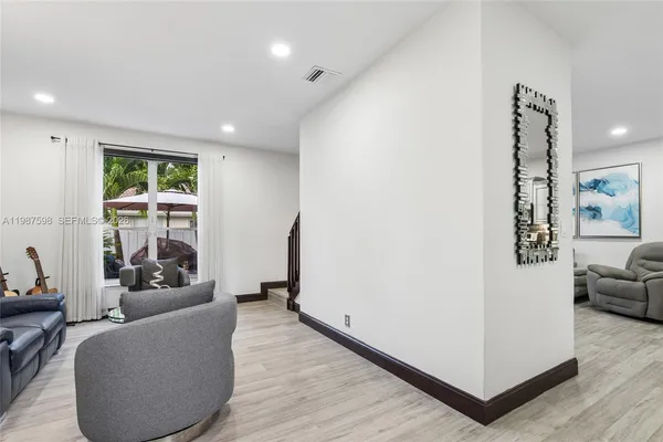 a living room with furniture and a large window