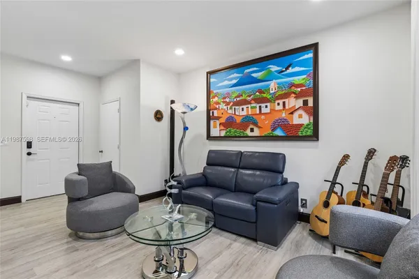 a living room with furniture a rug and a flat screen tv