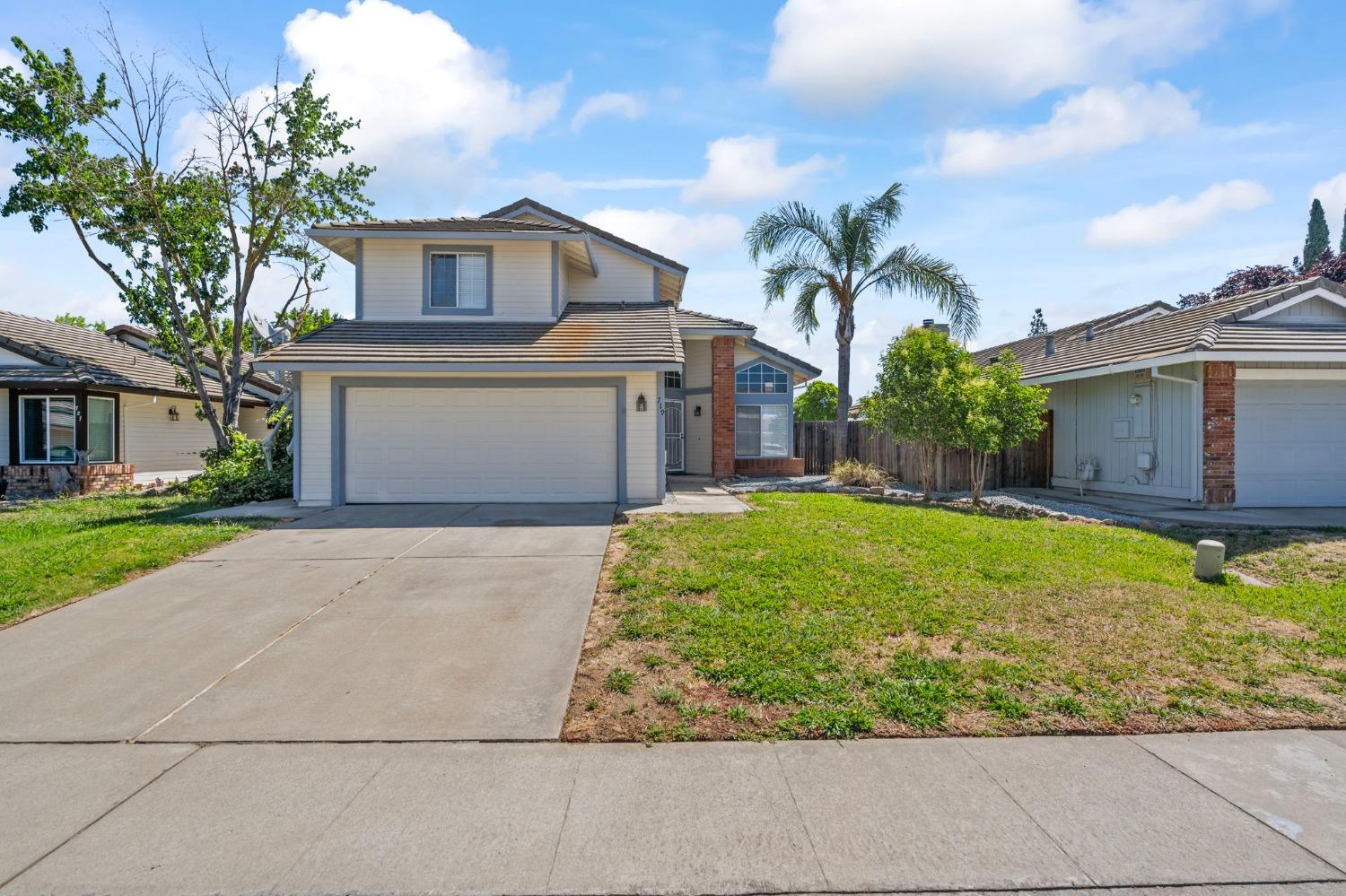719 Summit Lakes Way Galt, CA 95632 - Photo 1 of 1 a front view of a house with garden