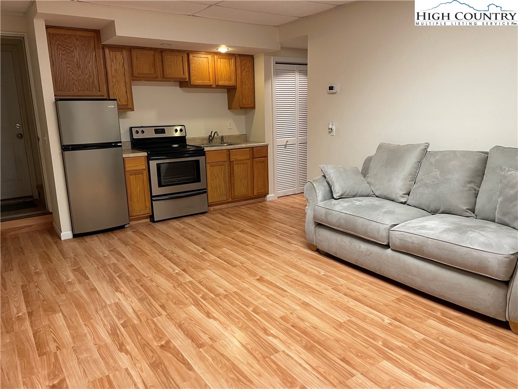 298 Russelton Road Boone, NC 28607 - Photo 19 of 28 a kitchen with stainless steel appliances granite countertop a refrigerator a stove and a wooden floors