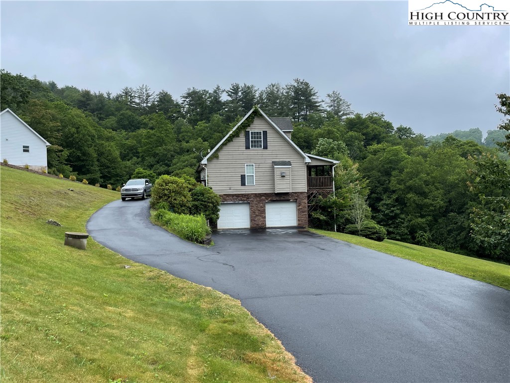 298 Russelton Road Boone, NC 28607 - Photo 26 of 28 a front view of a house with a yard and garage