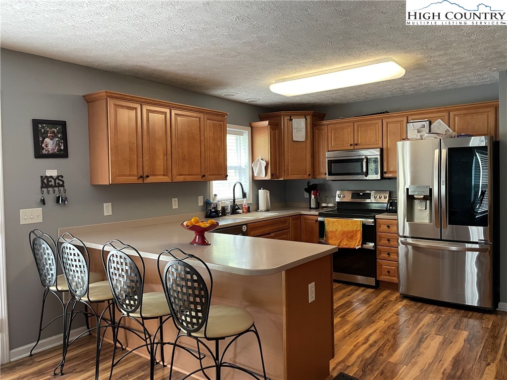 298 Russelton Road Boone, NC 28607 - Photo 3 of 28 a kitchen with stainless steel appliances granite countertop a refrigerator a stove top oven a sink and dishwasher