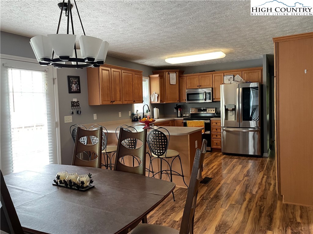 298 Russelton Road Boone, NC 28607 - Photo 4 of 28 a kitchen with granite countertop a sink appliances and cabinets