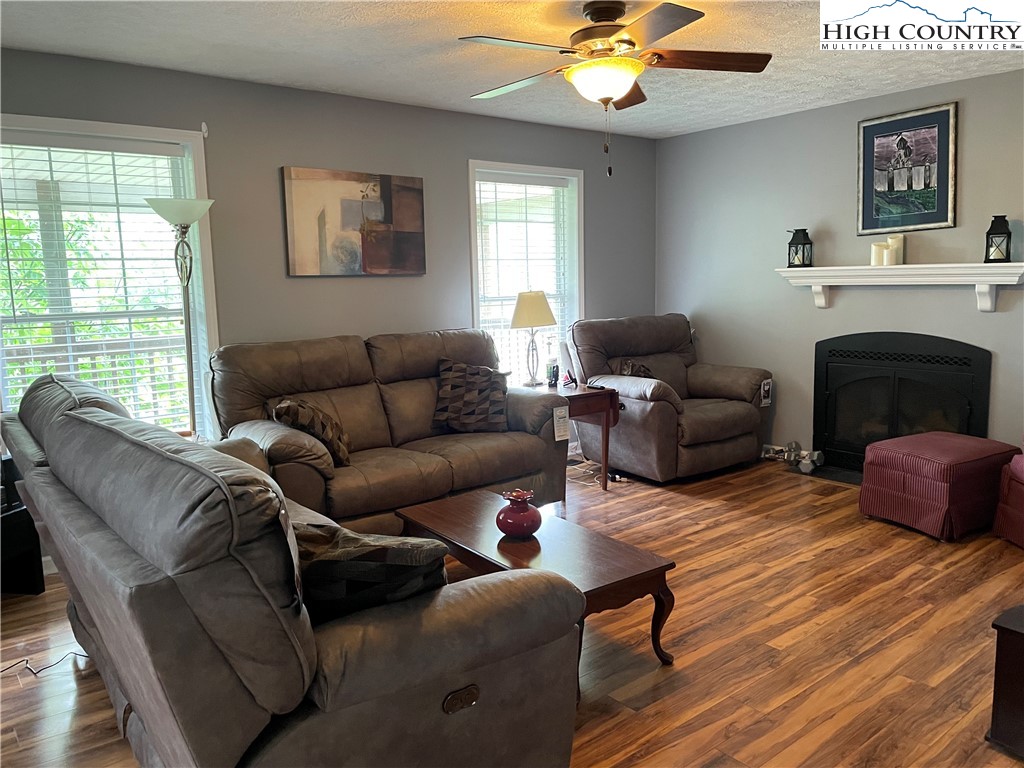 298 Russelton Road Boone, NC 28607 - Photo 6 of 28 a living room with furniture a chandelier and a fireplace