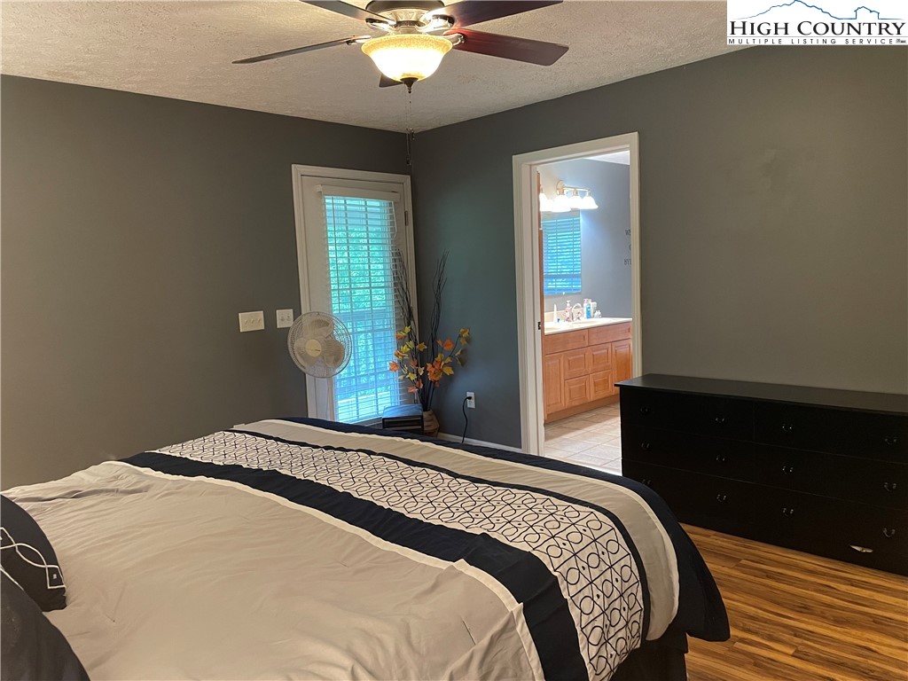 298 Russelton Road Boone, NC 28607 - Photo 7 of 28 a bedroom with a large bed and a chandelier