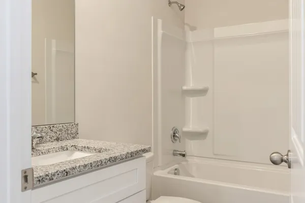 a bathroom with a bathtub and a sink