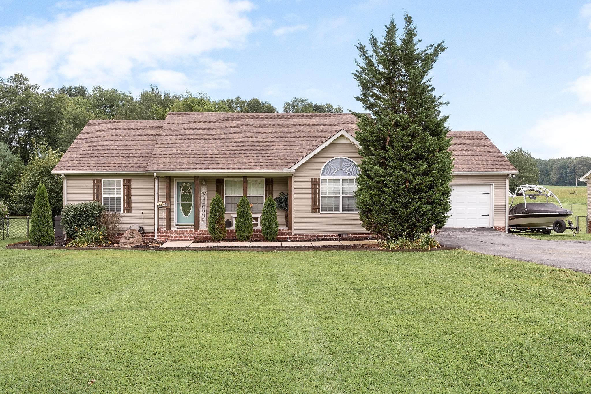 2964 Riley Creek Road Normandy, TN 37360 - Photo 1 of 18 a front view of a house with a garden and yard