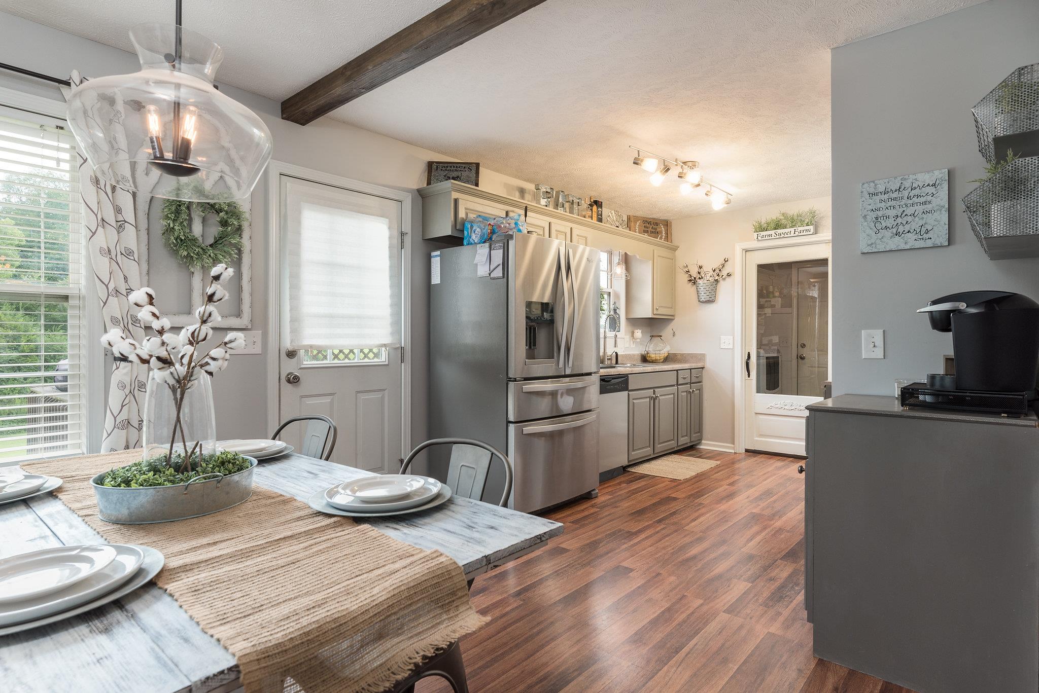 2964 Riley Creek Road Normandy, TN 37360 - Photo 5 of 18 a kitchen with granite countertop a refrigerator a stove a sink dishwasher a dining table and chairs with wooden floor