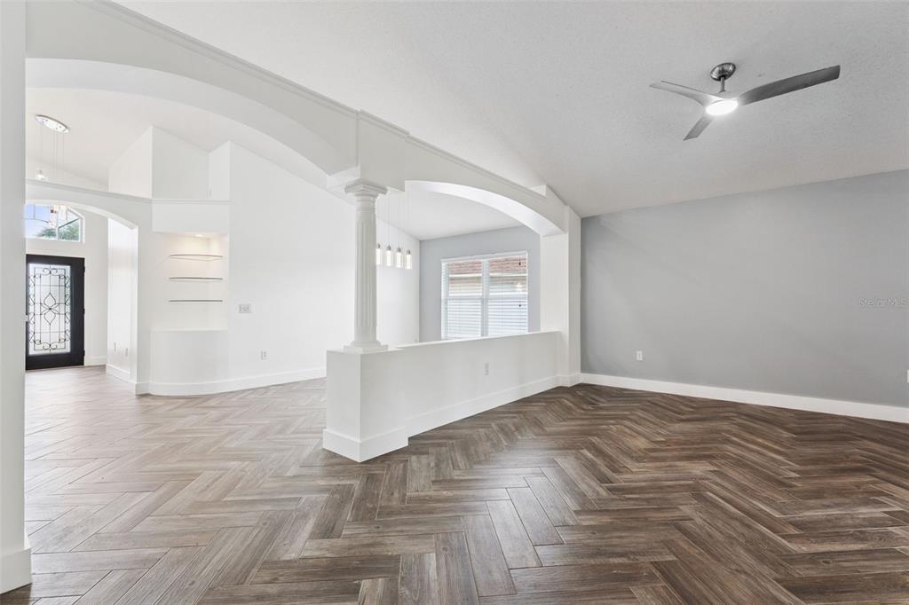 655 Eagle Pointe South Kissimmee, FL 34746 - Photo 14 of 49 wooden floor in an empty room with a window
