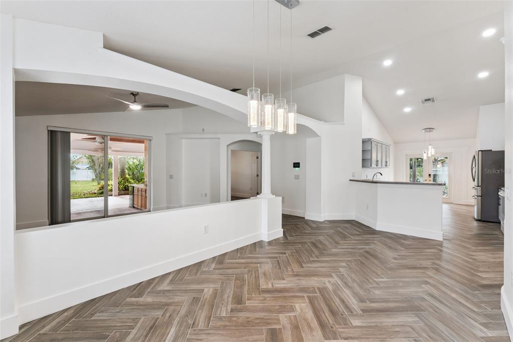 655 Eagle Pointe South Kissimmee, FL 34746 - Photo 15 of 49 a view of a big room with kitchen view and a chandelier