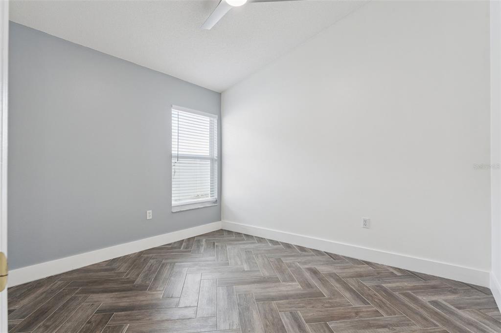 655 Eagle Pointe South Kissimmee, FL 34746 - Photo 17 of 49 a view of empty room with wooden floor and fan