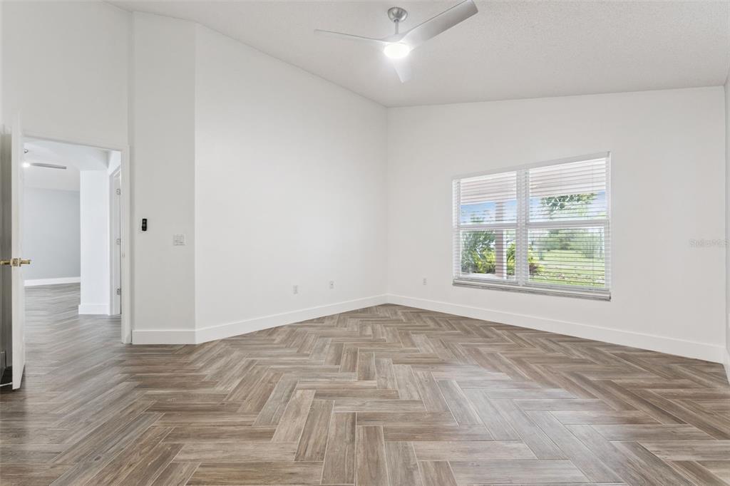 655 Eagle Pointe South Kissimmee, FL 34746 - Photo 21 of 49 an empty room with wooden floor and windows