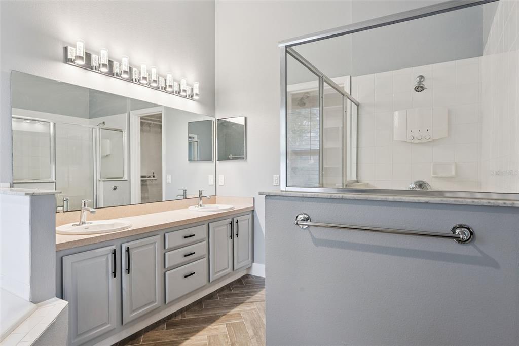 655 Eagle Pointe South Kissimmee, FL 34746 - Photo 25 of 49 a bathroom with a double vanity sink and a mirror