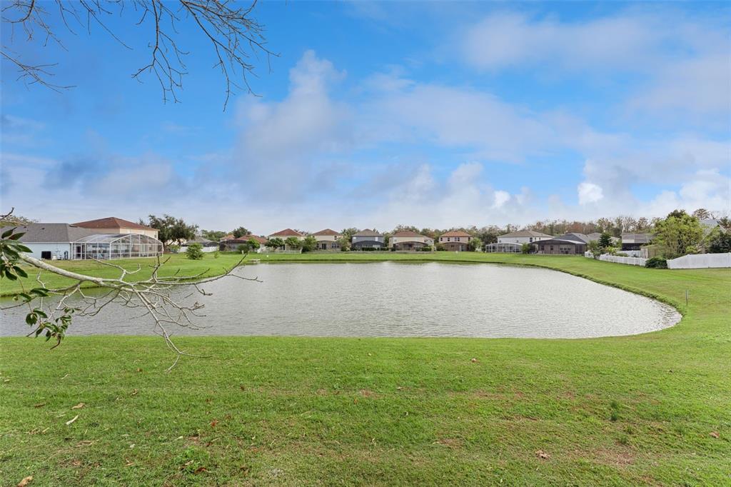655 Eagle Pointe South Kissimmee, FL 34746 - Photo 4 of 49 a view of a lake with houses in the back