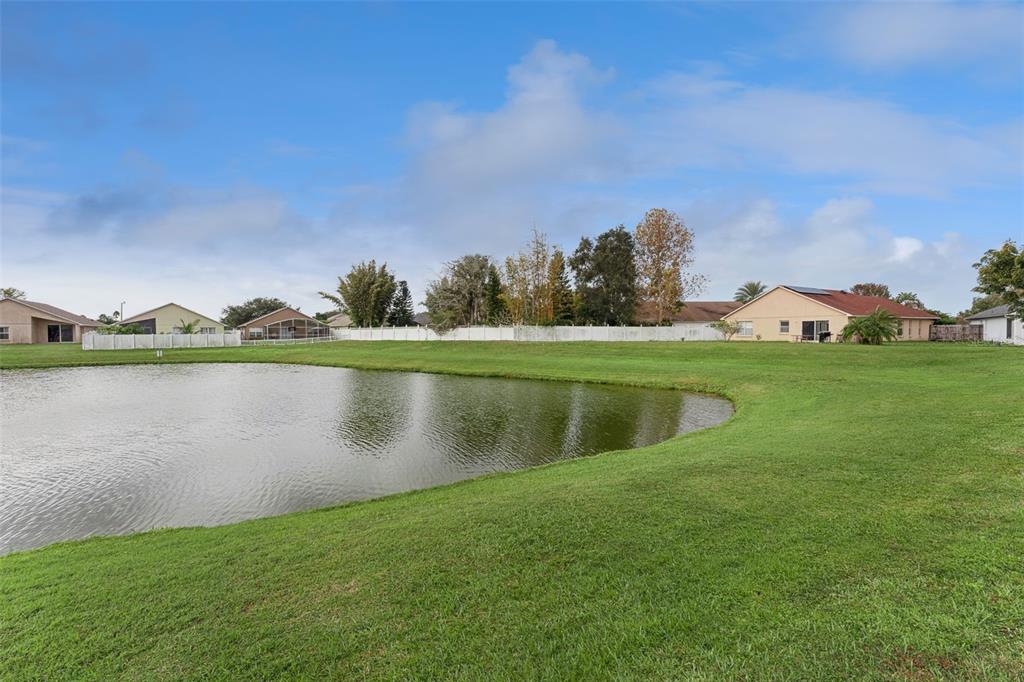 655 Eagle Pointe South Kissimmee, FL 34746 - Photo 43 of 49 a view of a lake with houses in the back