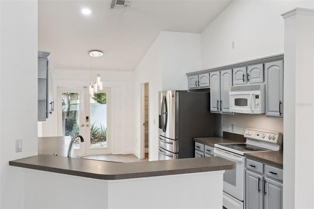 655 Eagle Pointe South Kissimmee, FL 34746 - Photo 7 of 49 a kitchen with stainless steel appliances granite countertop a refrigerator and a stove top oven