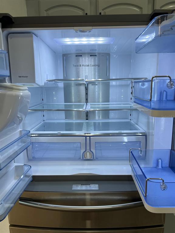 655 Eagle Pointe South Kissimmee, FL 34746 - Photo 10 of 49 a refrigerator in a kitchen