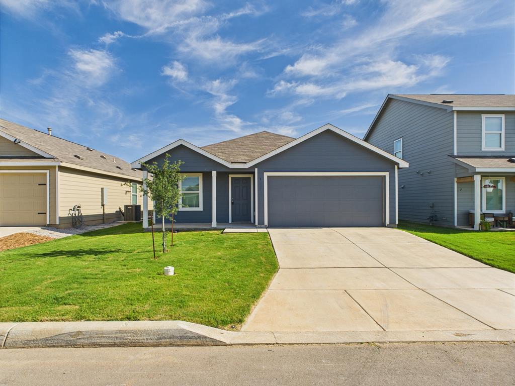 123 Aidan Trail Fredericksburg, TX 78624 - Photo 1 of 1 a front view of a house with a garden and yard