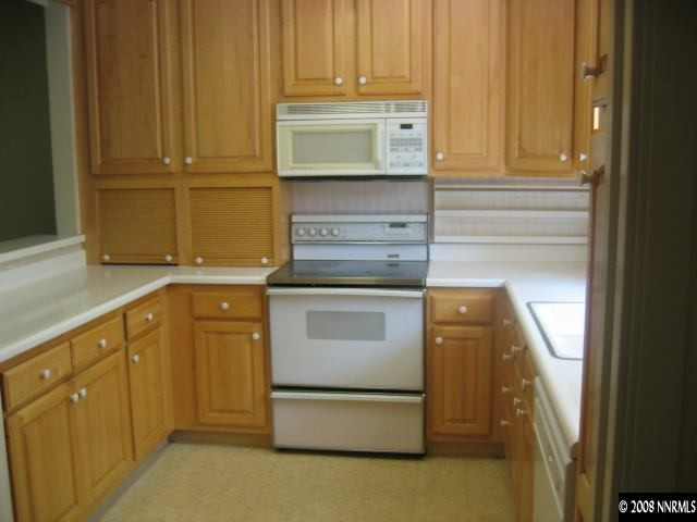 1917 South Villa Way Reno, NV 89509 - Photo 2 of 9 a kitchen with granite countertop white cabinets and stainless steel appliances
