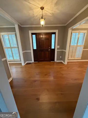 a view of an empty room with a fireplace and a window