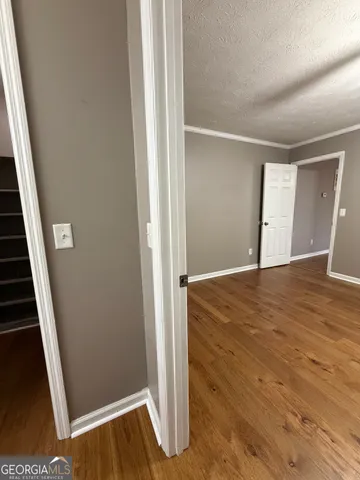 a view of walk in closet with empty racks
