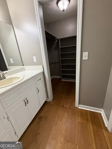 a view of a room with cabinets and wooden floor