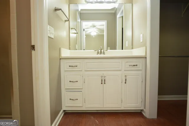 a bathroom with a sink vanity and a mirror
