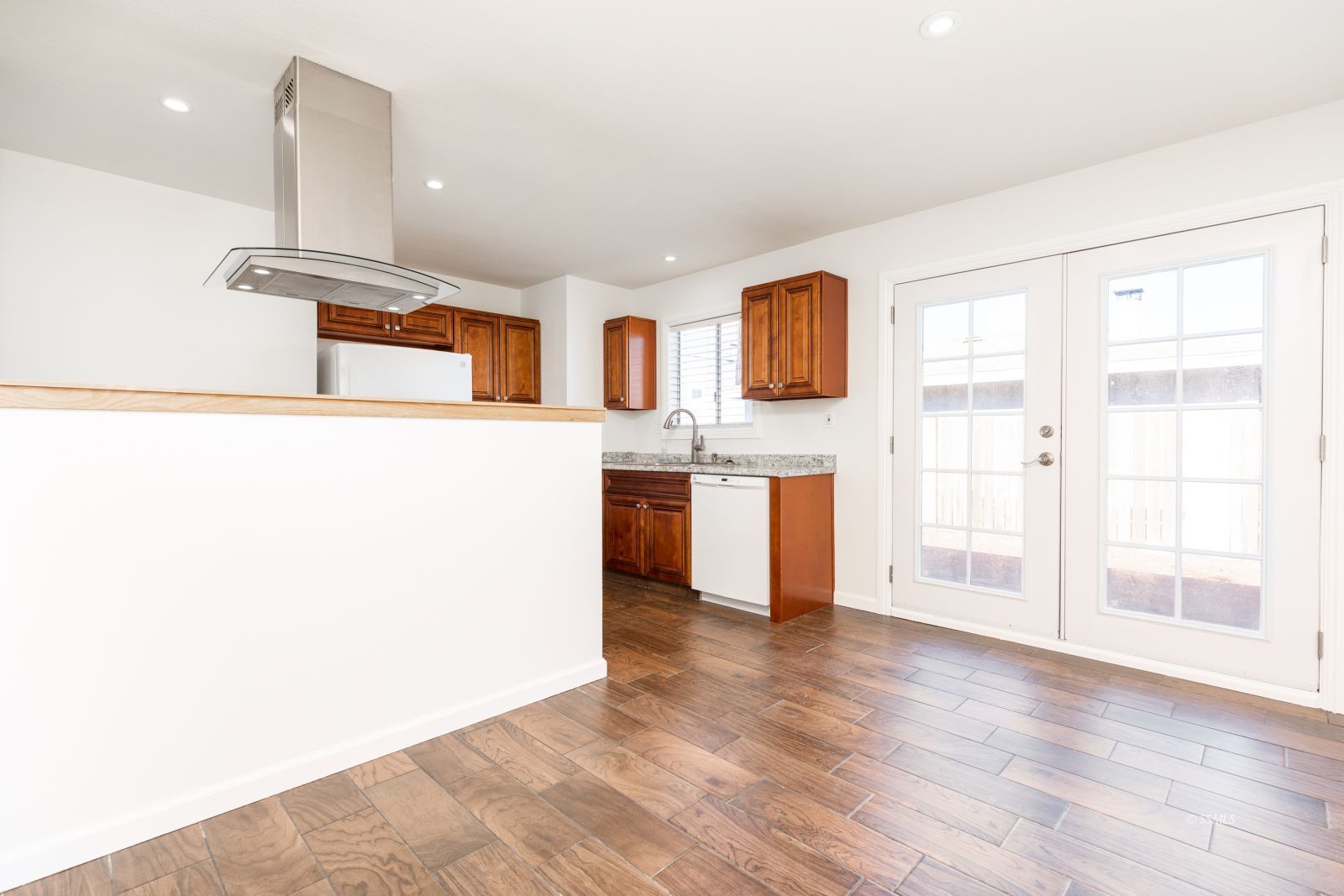 1425 Mayo Street Ridgecrest, CA 93555 - Photo 8 of 28 a kitchen with stainless steel appliances granite countertop a stove top oven a sink with wooden floors