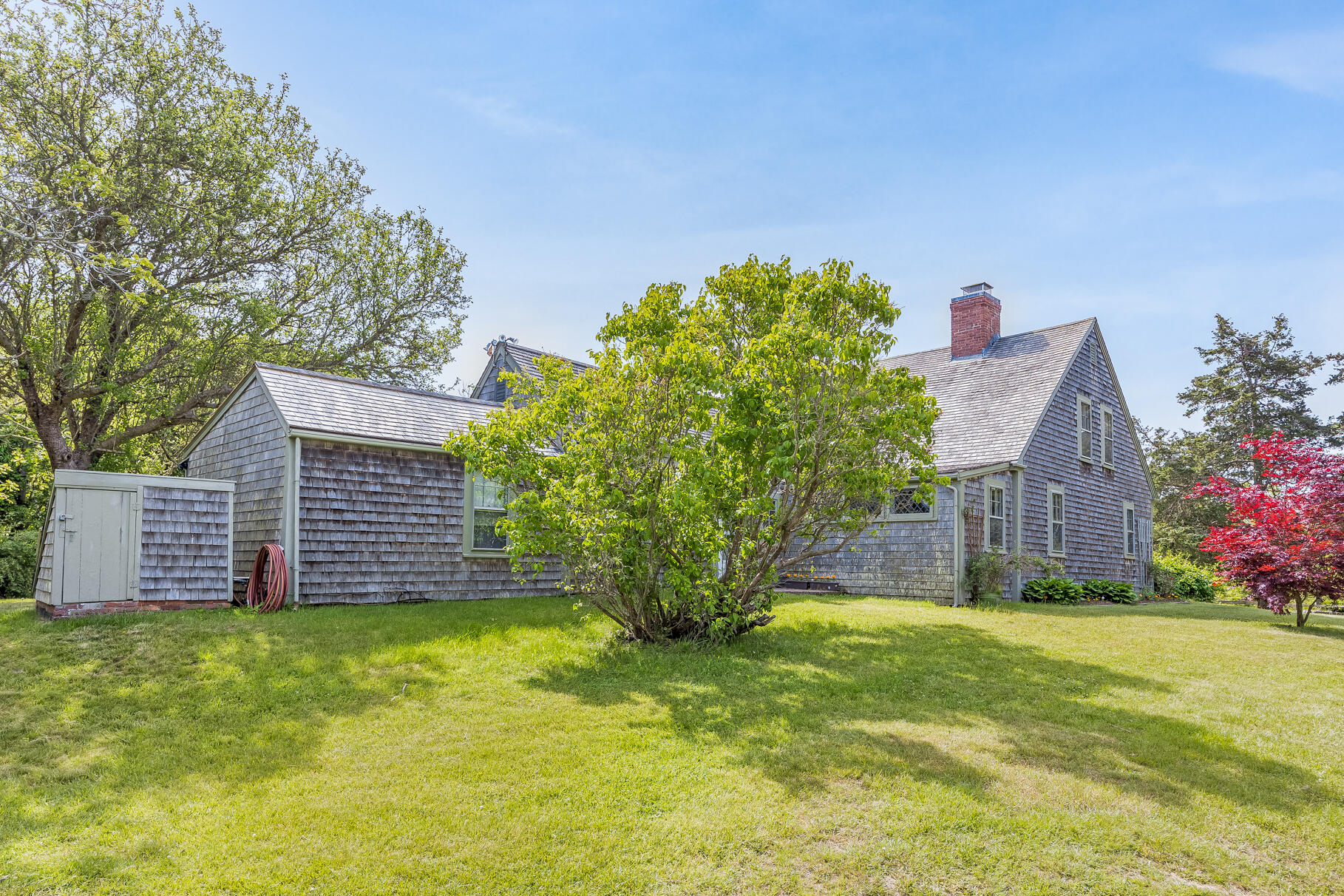 575 Nauset Road Eastham, MA 02642 - Photo 5 of 68 a view of a house with a yard plants and large tree