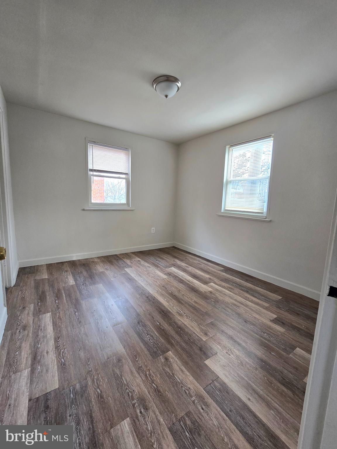 272 56th Street Northeast Washington, DC 20019 - Photo 11 of 13 wooden floor in an empty room with a window
