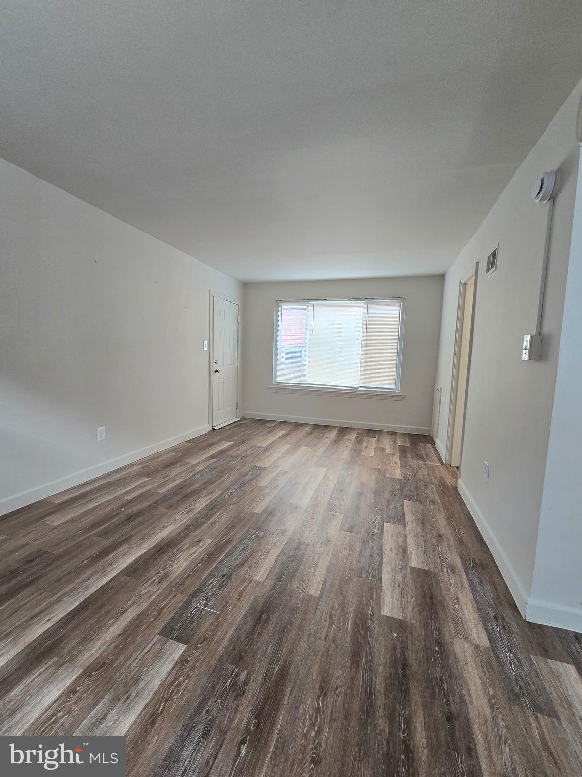 272 56th Street Northeast Washington, DC 20019 - Photo 12 of 13 wooden floor in an empty room with a window