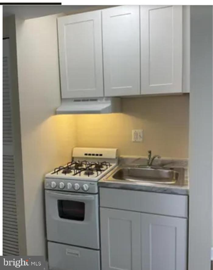 272 56th Street Northeast Washington, DC 20019 - Photo 4 of 13 a kitchen with granite countertop a sink and a stove