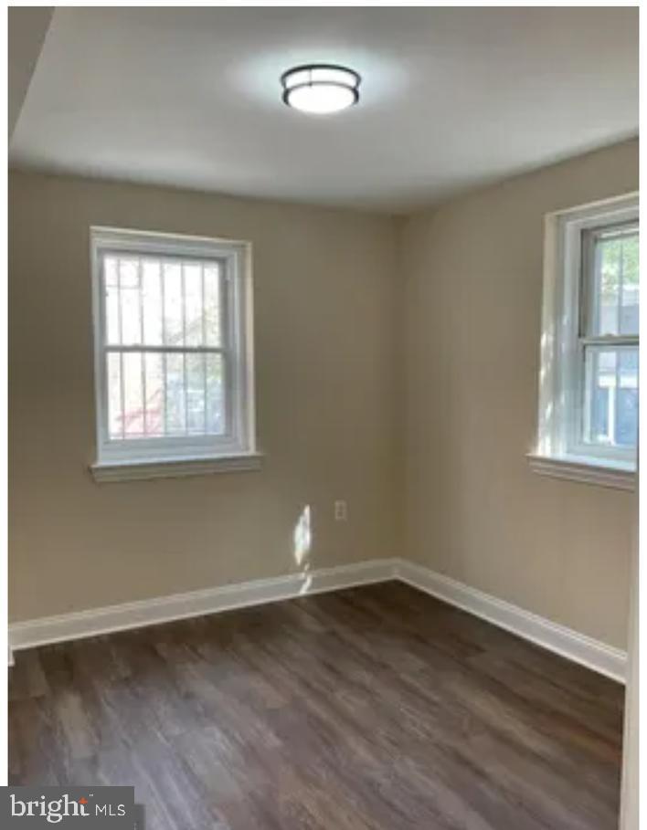 272 56th Street Northeast Washington, DC 20019 - Photo 7 of 13 an empty room with wooden floor and windows