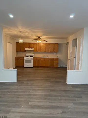 a kitchen with stainless steel appliances wooden cabinets a stove and a refrigerator