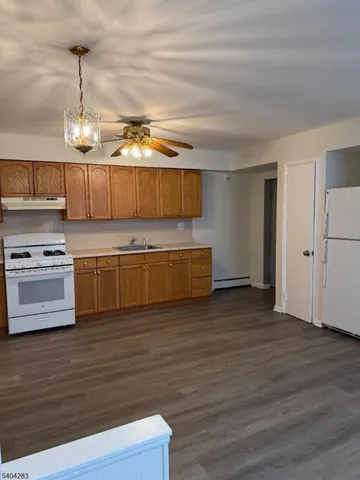 a view of a room with wooden floor and windows
