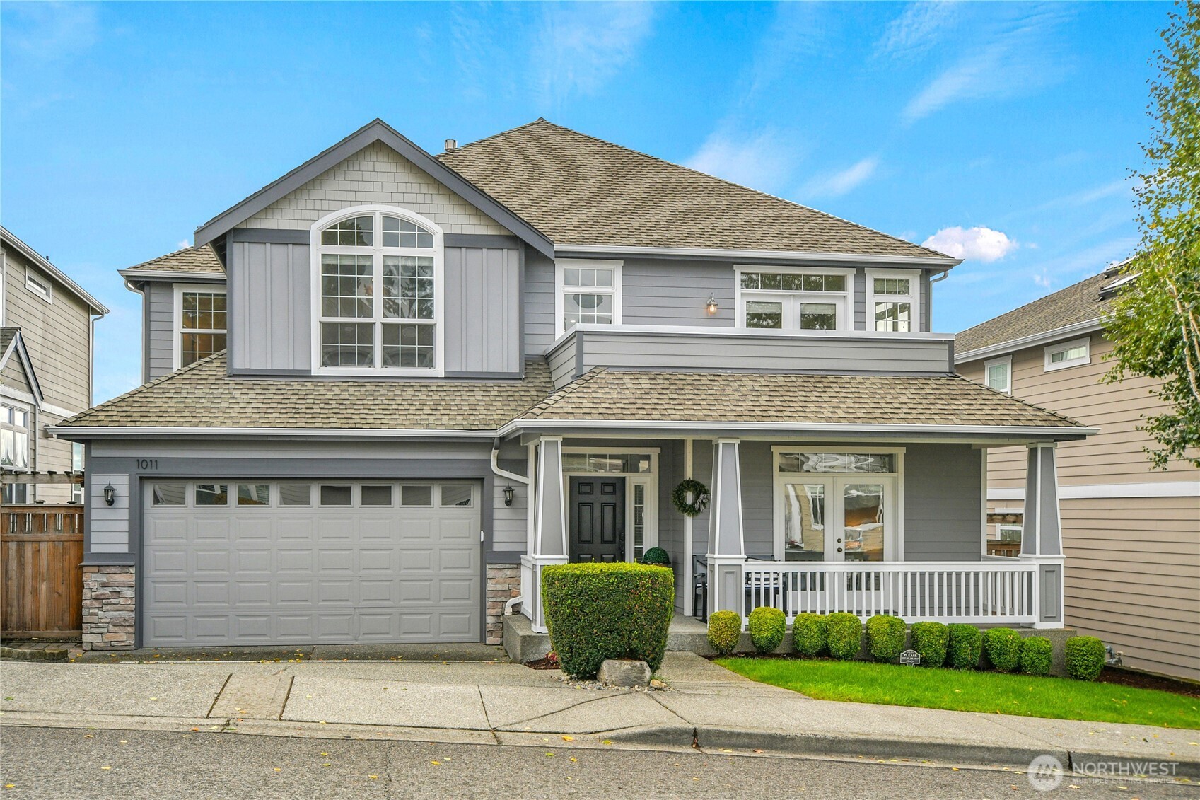 1011 North 27th Place Renton, WA 98056 - Photo 1 of 40 a front view of a house with a garden