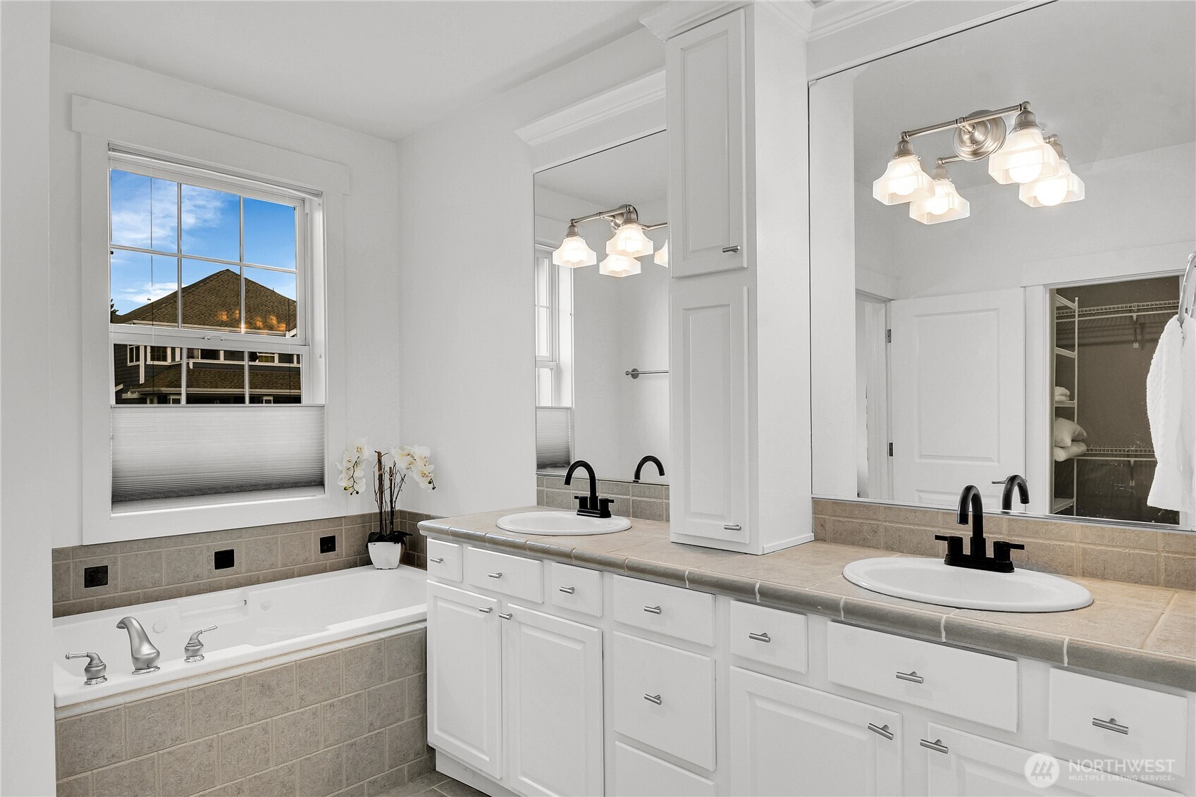 1011 North 27th Place Renton, WA 98056 - Photo 22 of 40 a bathroom with a double vanity sink and a mirror