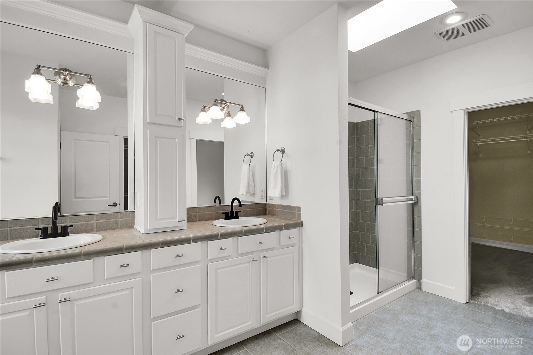 1011 North 27th Place Renton, WA 98056 - Photo 23 of 40 a bathroom with a granite countertop sink and a mirror