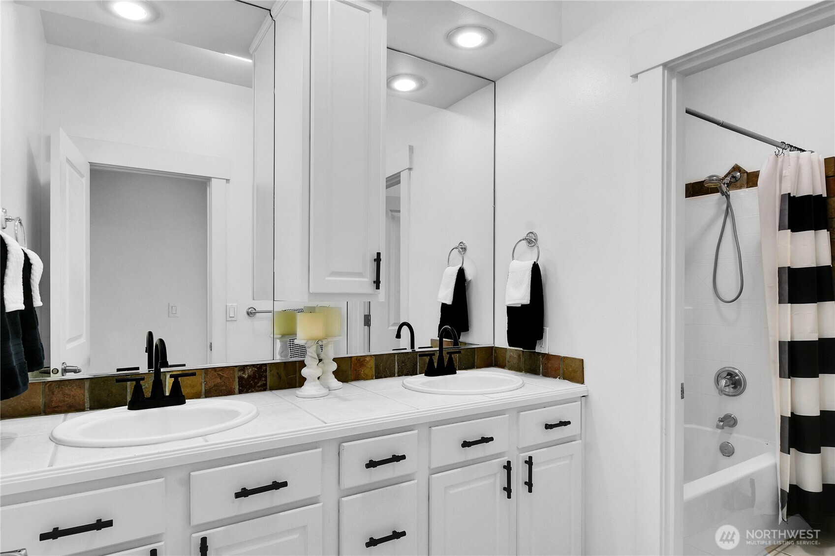 1011 North 27th Place Renton, WA 98056 - Photo 28 of 40 a bathroom with a double vanity sink mirror and shower
